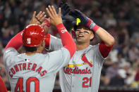 St. Louis Cardinals' Lars Nootbaar (21) smiles as he celebrates his two-run home run against the Arizona Diamondbacks with Cardinals' Willson Contreras, left, during the third inning of a baseball game Friday, April 12, 2024, in Phoenix. (AP Photo/Ross D. Franklin)