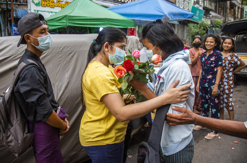 FILE - In this March 26, 2021, file photo, an anti-coup student protester is welcomed home with flowers by the residents of her neighborhood after being released from jail in Yangon, Myanmar. The military takeover of Myanmar early in the morning of Feb. 1 reversed the country's slow climb toward democracy after five decades of army rule. But Myanmar's citizens were not shy about demanding their democracy be restored. (AP Photo, File)