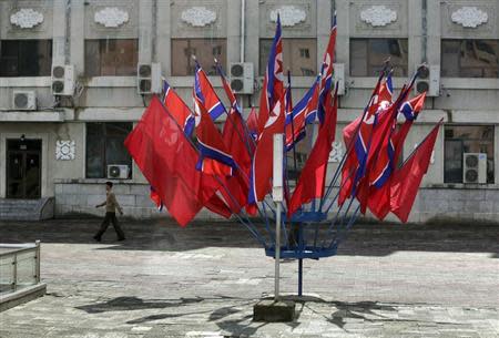 A man walks past North Korean national flags in Pyongyang July 29, 2013. REUTERS/Jason Lee