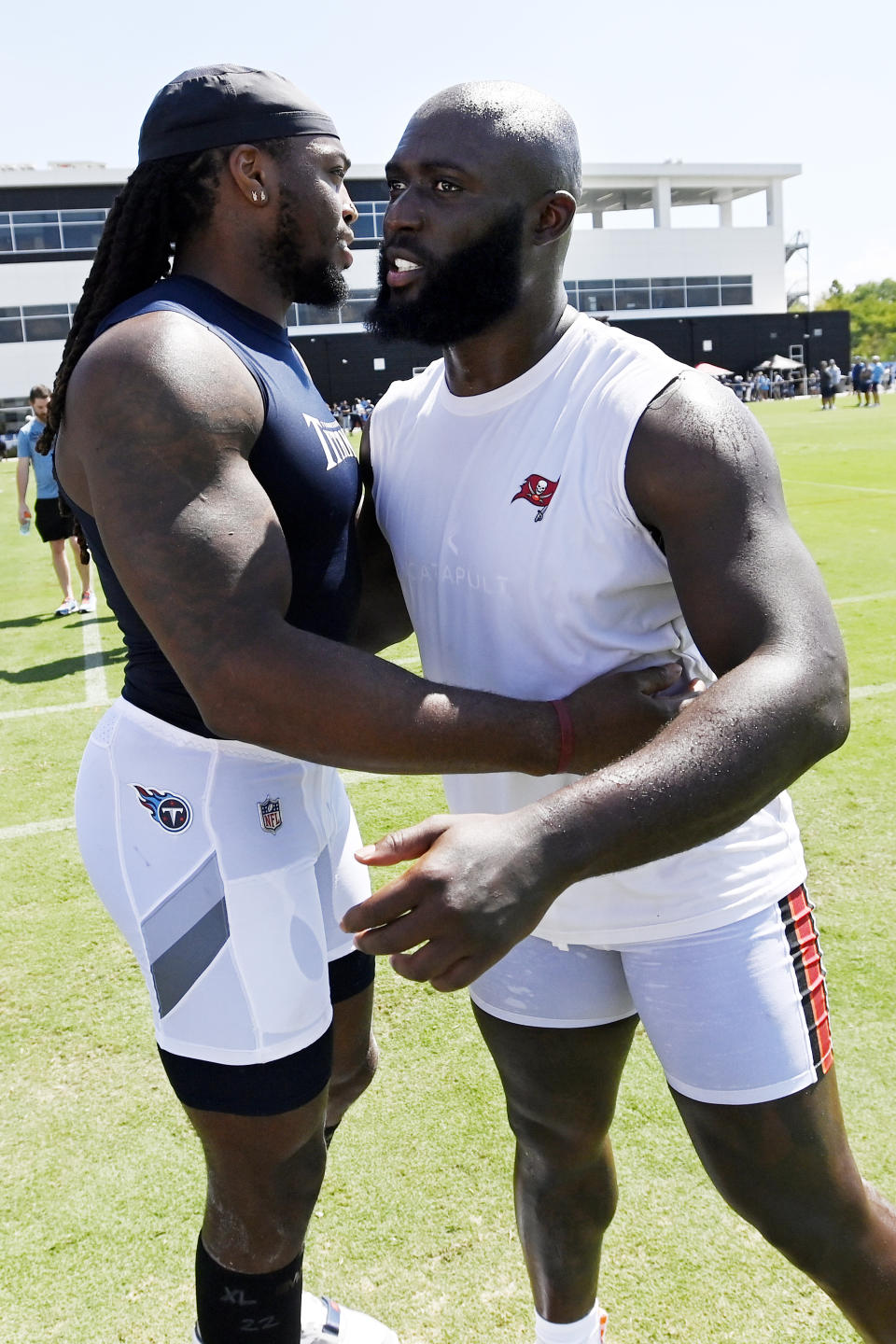 Tennessee Titans running back Derrick Henry, left, and Tampa Bay Buccaneers running back Leonard Fournette talk after a combined NFL football training camp, Thursday, Aug. 18, 2022, in Nashville, Tenn. (AP Photo/Mark Zaleski)