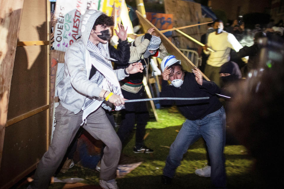 FILE - Demonstrators clash at a pro-Palestinian encampment at UCLA early Wednesday, May 1, 2024, in Los Angeles. (AP Photo/Ethan Swope, File)