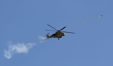 An Iraqi Air Force helicopter fires a rocket towards Islamic State militants during heavy fighting in Salahuddin province, March 4, 2015. REUTERS/ Mahmoud Raouf