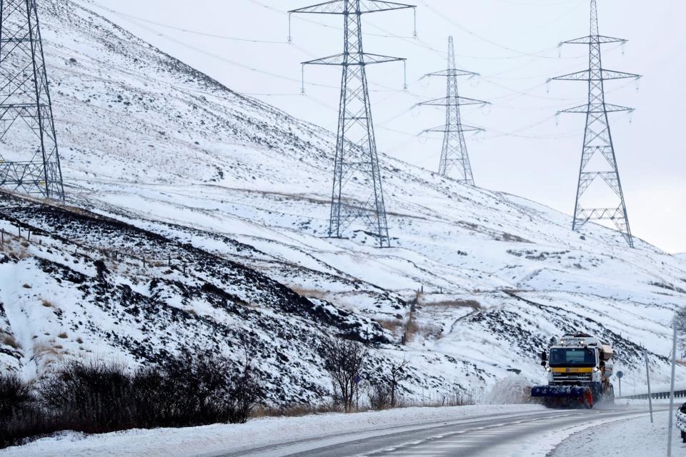 A snow plough clears the A9 near Dalwhinnie, Scotland (REUTERS)