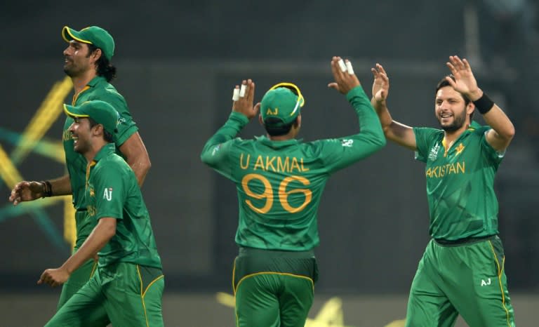 Pakistan's captain Shahid Afridi(right) celebrates with teammates after the dismissal of Bangladesh's batsman Sabbir Rahman during the World T20 tournament match at The Eden Gardens stadium in Kolkata on March 16, 2016