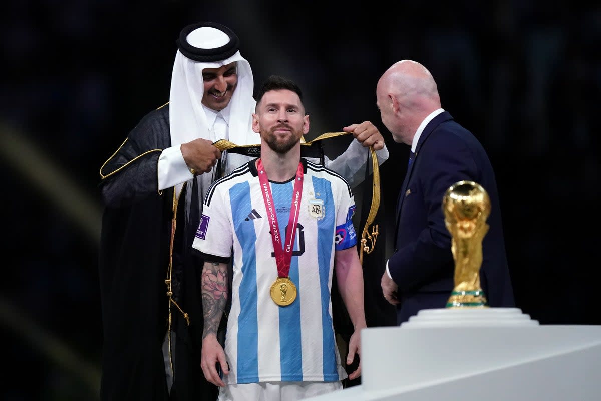 Messi was wrapped in a bisht by the Emir of Qatar after winning the World Cup (PA Wire)