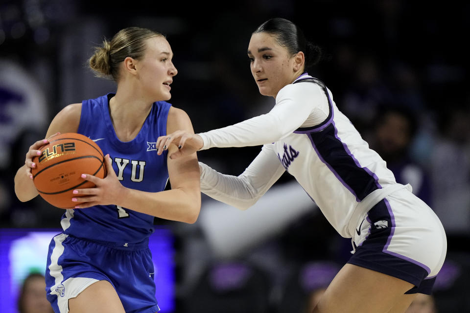 Kansas State guard Jaelyn Glenn, right, tries to steal the ball from BYU guard Amari Whiting during the second half of an NCAA college basketball game Saturday, Jan. 27, 2024, in Manhattan, Kan. Kansas State won 67-65. (AP Photo/Charlie Riedel)
