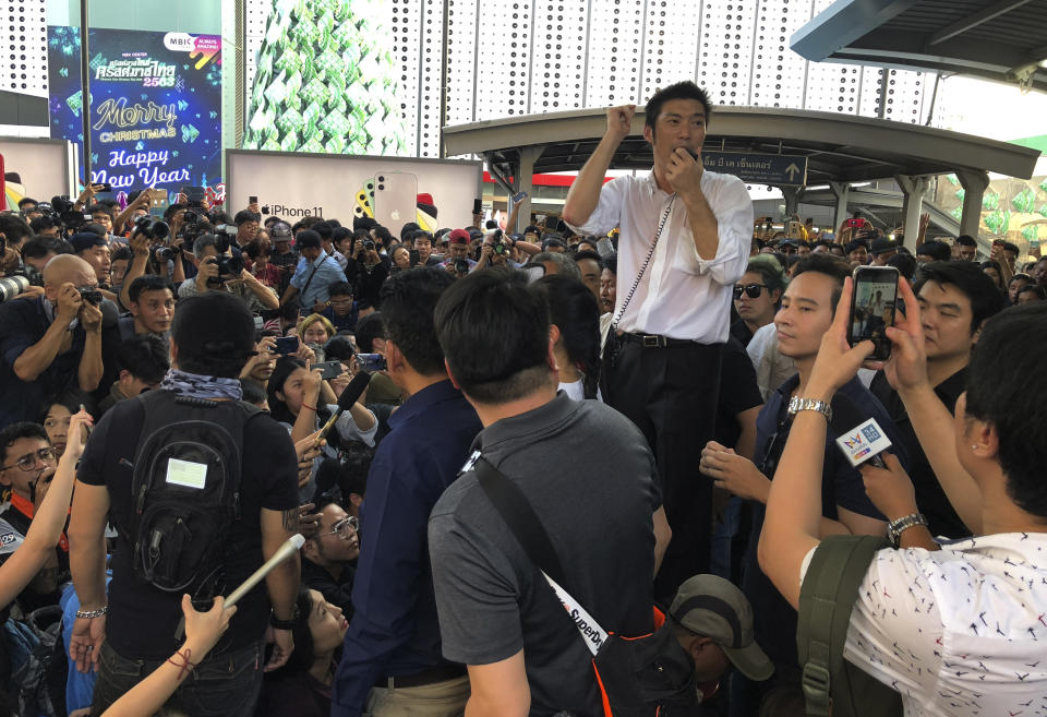 Thailand's Future Forward Party leader Thanathorn Juangroongruangkit talks to his supporters during a rally in Bangkok, Thailand, Saturday, Dec. 14, 2019. Several thousand supporters of a popular Thai political party, under threat of dissolution, packed a concourse in central Bangkok on Saturday in one of the largest political demonstrations in recent years. (AP Photo/Jerry Harmer)