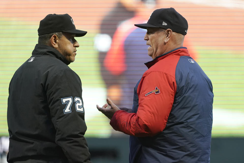 Atlanta Braves manager Brian Snitker, right, talks with umpire Alfonso Marquez during the fourth inning of the team's baseball game against the San Francisco Giants in San Francisco, Saturday, Sept. 18, 2021. (AP Photo/Jeff Chiu)