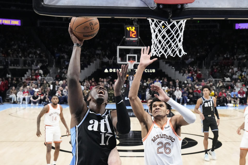 Atlanta Hawks forward Onyeka Okongwu (17) goes up for a shot as San Antonio Spurs forward Dominick Barlow (26) defends during the first half of an NBA basketball game Monday, Jan. 15, 2024, in Atlanta. (AP Photo/John Bazemore)