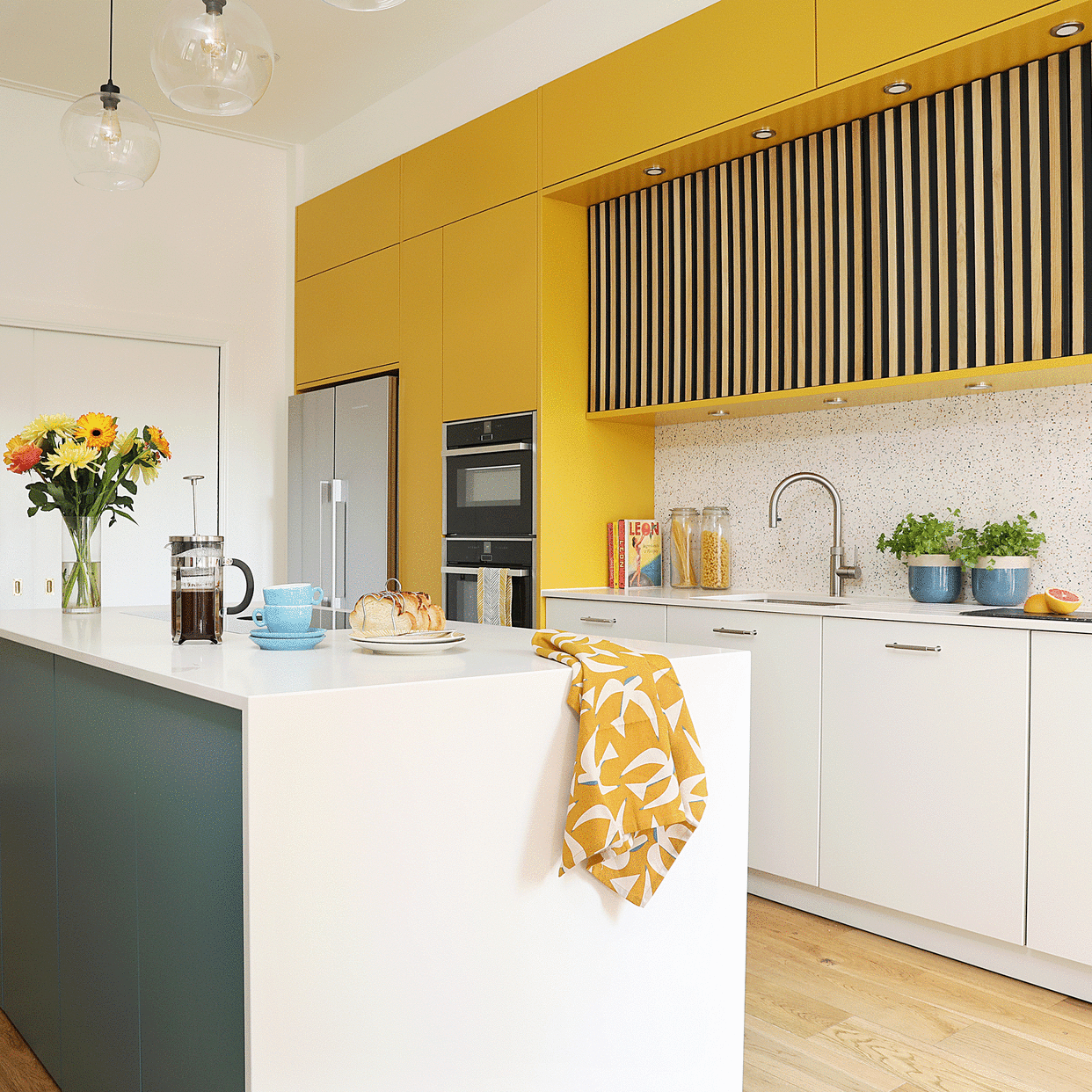  Yellow kitchen with white countertop. 