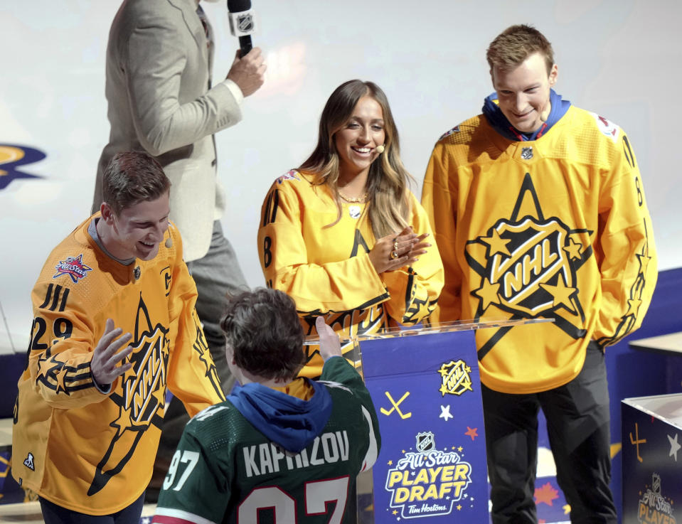 Nathan MacKinnon, left, of Team MacKinnon picks Kirill Kaprizov as Tate McRae and Cale Makar look on during the NHL All-Star hockey week draft in Toronto on Thursday, Feb. 1, 2024. (Nathan Denette/The Canadian Press via AP)