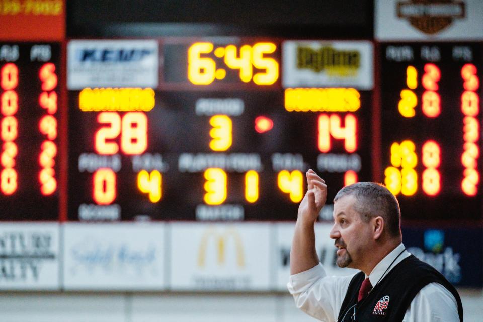 New Phila's coach Matt Voll is seen from the bench during the Division II sectional final game against John Glenn.