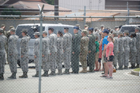 U.S. soldiers and people salute vehicles transporting the remains of 55 U.S. soldiers who were killed in the Korean War at Osan Air Base in Pyeongtaek, South Korea, July 27, 2018. REUTERS/Kim Hong-Ji/Pool