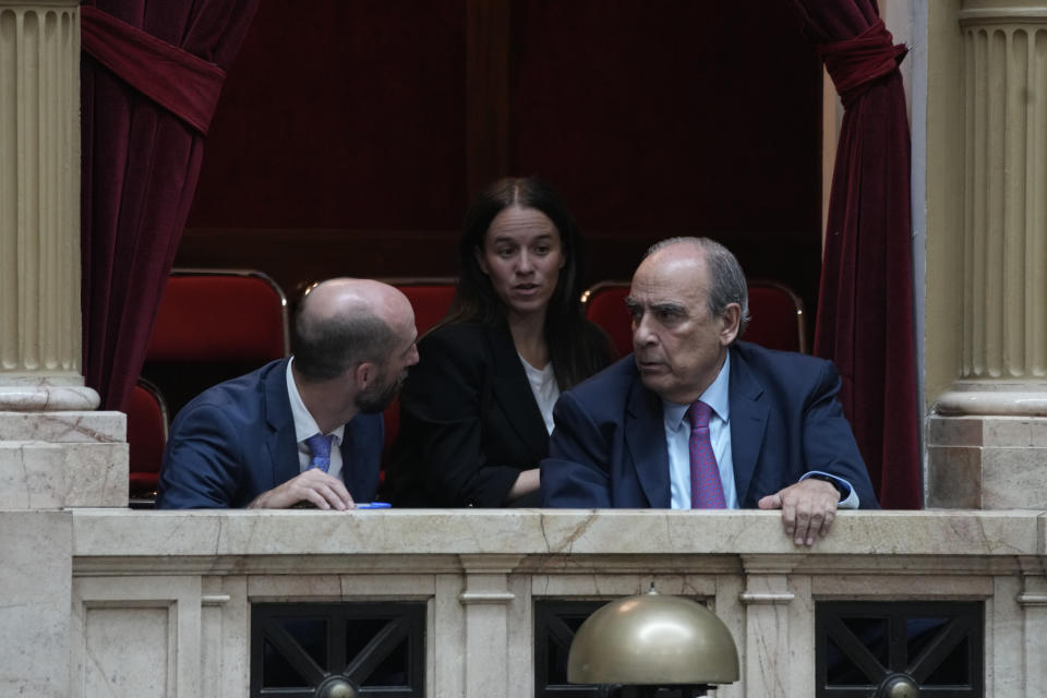 Interior Minister Guillermo Francos, right, attends lawmakers' debate on a bill promoted by Argentine President Javier Milei that includes a broad range of economic, administrative, criminal, and environmental reforms, at Congress in Buenos Aires, Argentina, Tuesday, April 30, 2024. (AP Photo/Natacha Pisarenko)