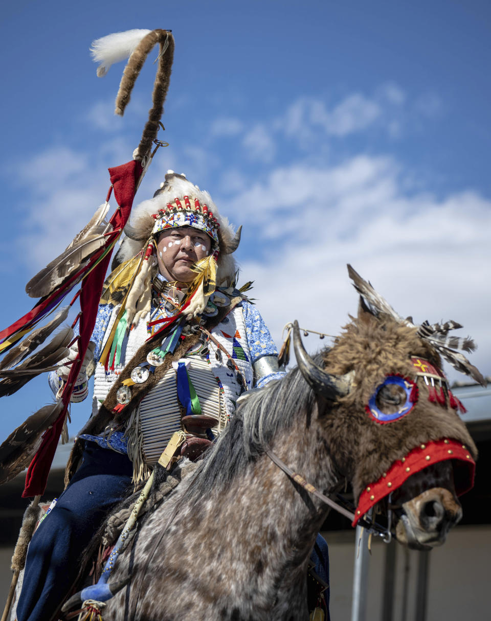 Shane Redhawk who is Sicangu Lakota leads a horse parade at the 40th anniversary of the Gathering of Nations Pow Wow in Albuquerque, N.M., Friday, April 28, 2023. Tens of thousands of people gathered in New Mexico on Friday for what organizers bill as the largest powwow in North America. (AP Photo/Roberto E. Rosales)