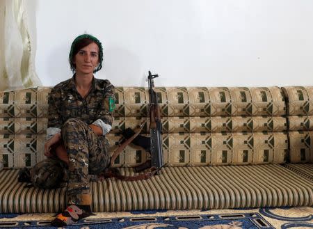 Sheen Ibrahim, Kurdish fighter from the People's Protection Units (YPG) sits inside a house in Raqqa, Syria June 16, 2017. REUTERS/Goran Tomasevic