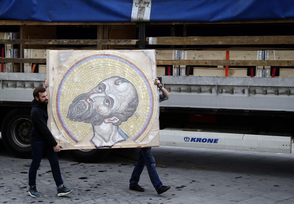 Workers carry a mosaic depicting Jesus Christ in Belgrade