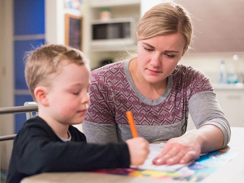 mom parent kid helping homework