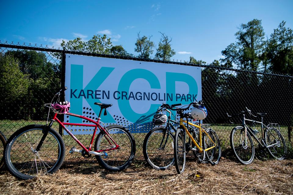 Bikes are leaned against a fence at Karen Cragnolin Park during the dedication of the newest portion of the French Broad River Greenway, August 25, 2023.