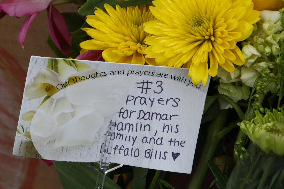 A card with flowers is shown outside Highmark Stadium to show support for injured Buffalo Bills NFL football player Damar Hamlin in Orchard Park, N.Y., Thursday Jan. 5, 2023. (AP Photo/Jeffrey T. Barnes)