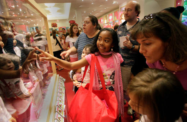 A young girl picks her new doll at the American Girl store in McLean, Va. in June 2011.