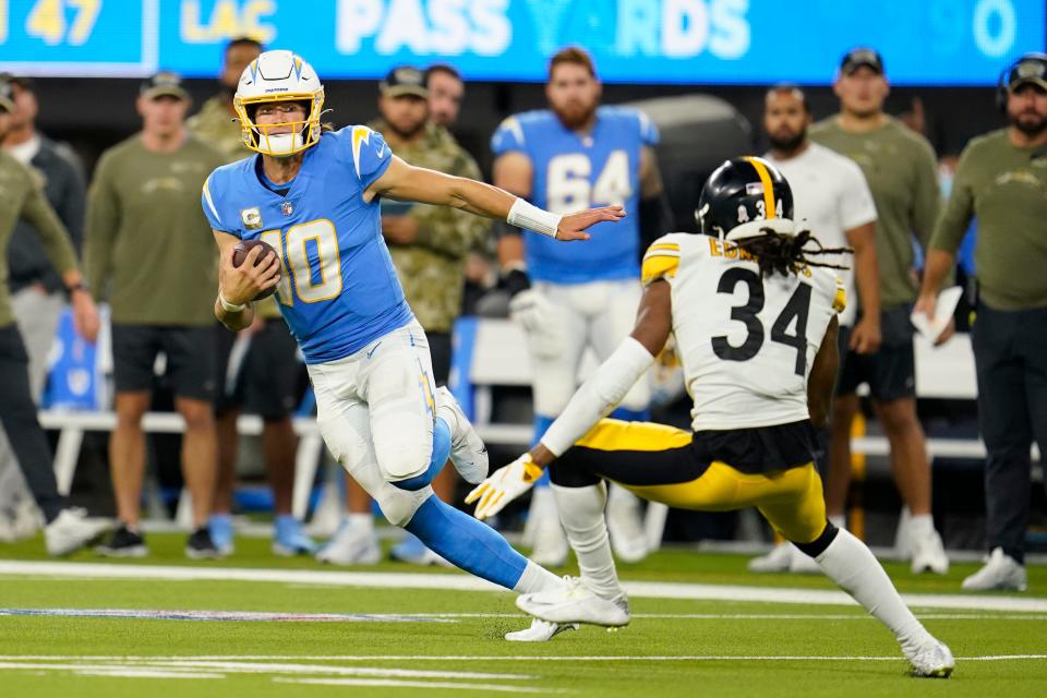 Los Angeles Chargers quarterback Justin Herbert ran for 90 yards against safety Terrell Edmunds (34) and the Pittsburgh Steelers in Sunday's 41-37 win at Sofi Stadium in Inglewood, Calif.