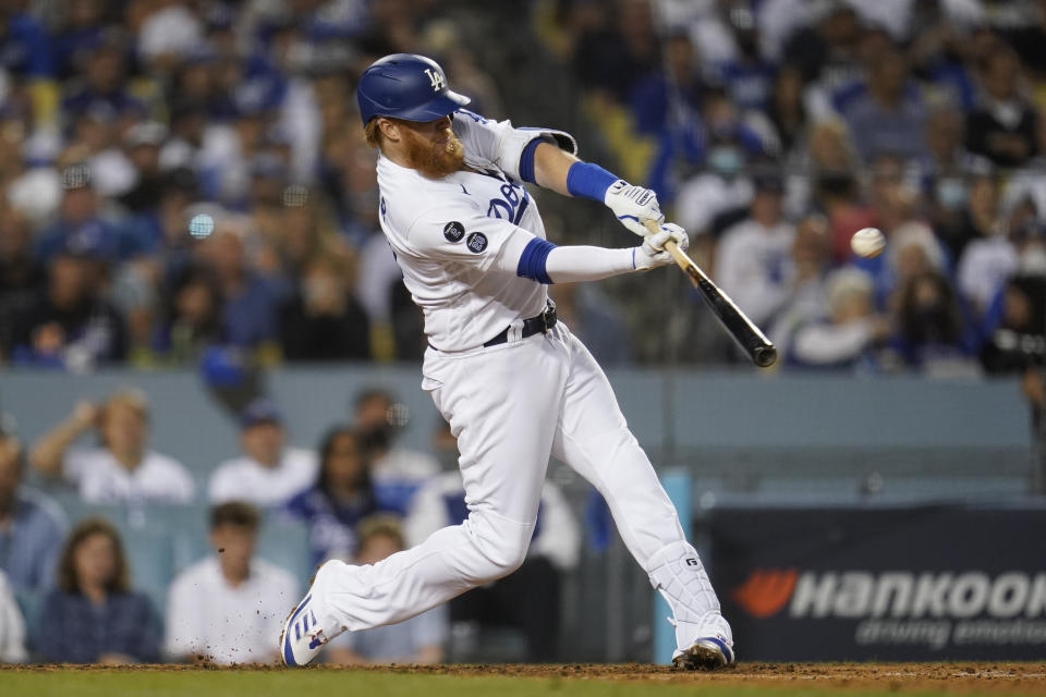 Los Angeles Dodgers' Justin Turner hits a solo home run during the fourth inning of a National League Wild Card playoff baseball game against the St. Louis Cardinals Wednesday, Oct. 6, 2021, in Los Angeles. (AP Photo/Marcio Jose Sanchez)