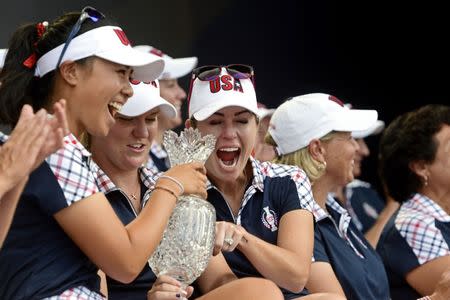 Aug 20, 2017; West Des Moines, IA, USA; Danielle Kang, Austin Ernst and Paula Creamer hold the Solheim Cup during the closing ceremony of The Solheim Cup international golf tournament at Des Moines Golf and Country Club. Thomas J. Russo-USA TODAY Sports