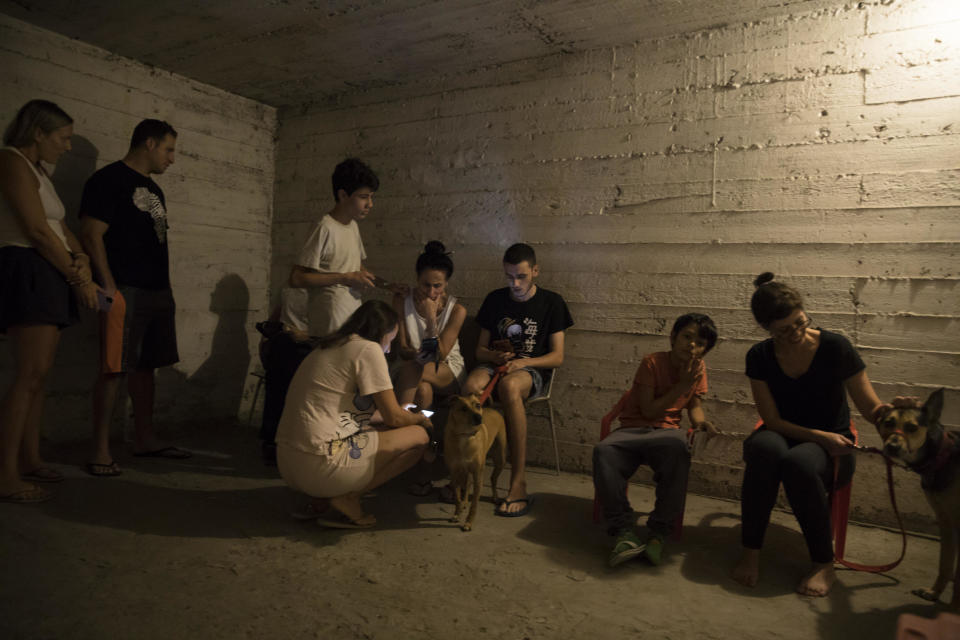 People take refuge in a shelter as sirens are heard on October 7, 2023, in Tel Aviv, Israel. / Credit: AMIR LEVY / Getty Images