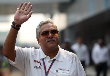 Force India team principal Vijay Mallya waves in the paddock during the third practice session of the Indian F1 Grand Prix at the Buddh International Circuit in Greater Noida, on the outskirts of New Delhi, October 27, 2012. REUTERS/Ahmad Masood