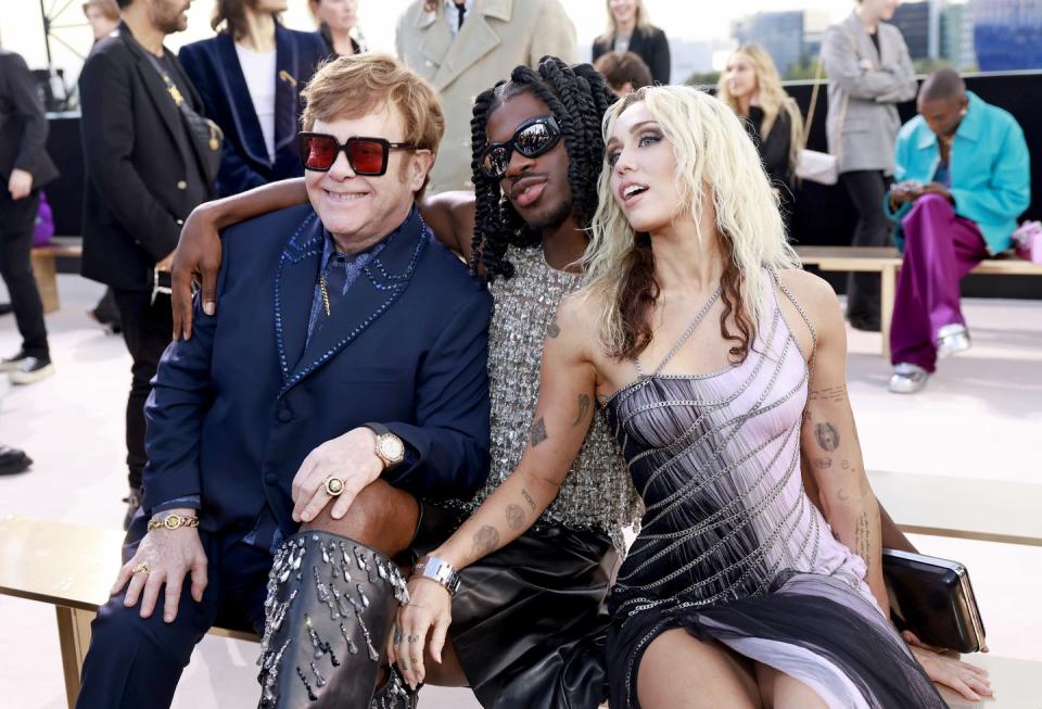 west hollywood, california march 09 l r elton john, lil nas x, and miley cyrus attend the versace fw23 show at pacific design center on march 09, 2023 in west hollywood, california photo by emma mcintyregetty images