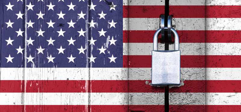 US flag on a wooden door locked with a padlock