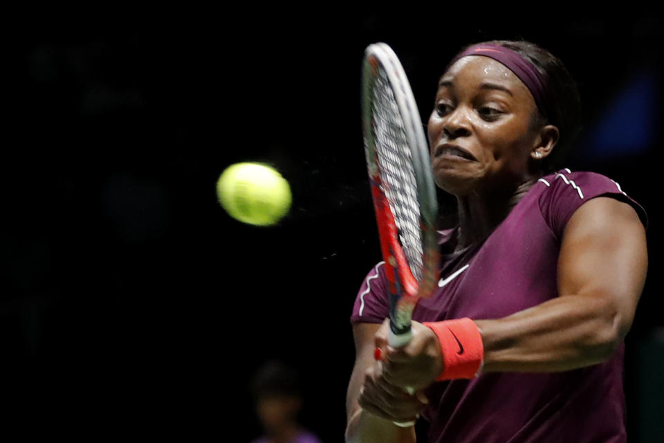 Sloane Stephens of the United States makes a backhand return to Naomi Osaka of Japan during their women's singles match at the WTA tennis tournament in Singapore on Monday, Oct. 22, 2018. (AP Photo/Vincent Thian)