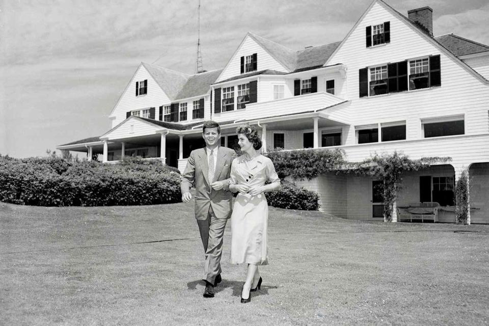 <p>Bettmann/Getty</p> John F. Kennedy and Jackie Kennedy at his family home