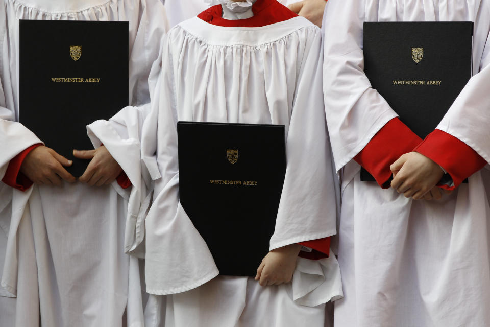 Altar boys wait to bid farewell to Britain's Queen Elizabeth II, not seen, following the Commonwealth Day Observance at Westminster Abbey in central London, Monday, March 12, 2012. (AP Photo/Lefteris Pitarakis)