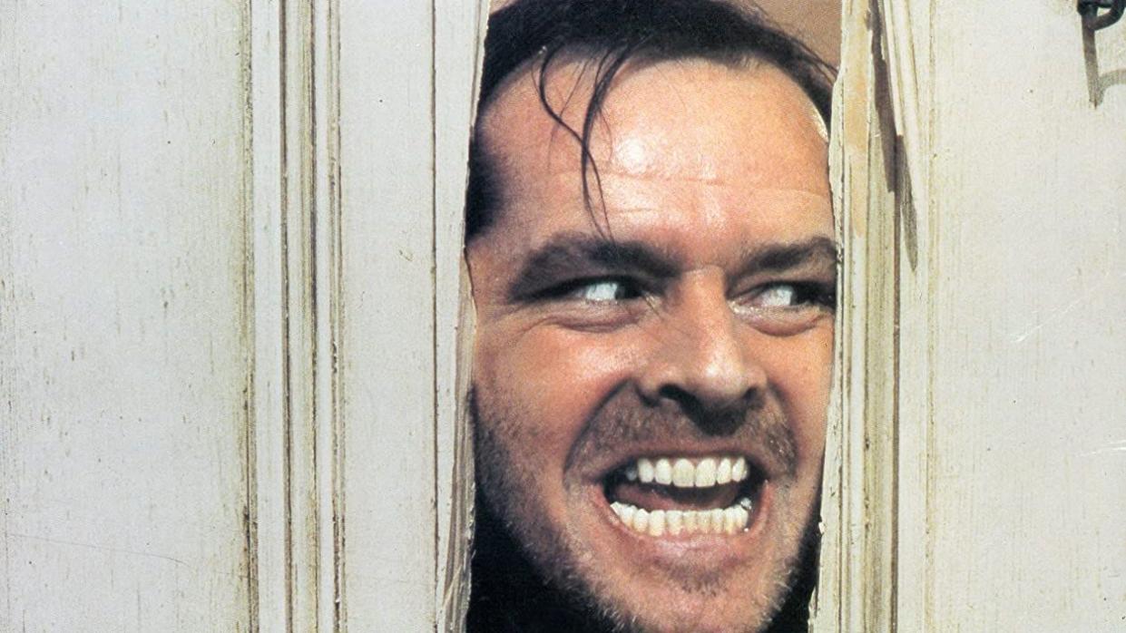 jack busts through a door in a scene from the shining a good housekeeping pick for best halloween movies