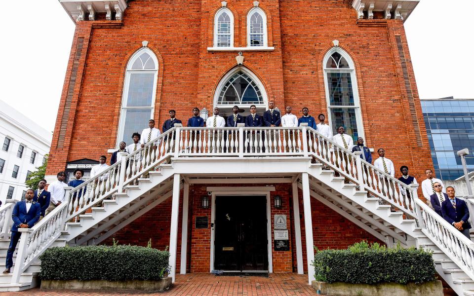 The Valiant Cross Academy senior class pose with school co founders Anthony and Frederick Brock at Dexter Avenue King Memorial Baptist Church, in Montgomery, Ala., on Monday August 16, 2021.