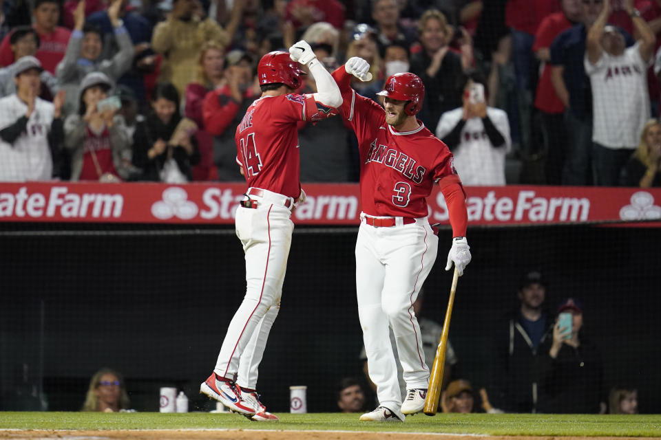 Los Angeles Angels' Tyler Wade (14) celebrates with designated hitter Taylor Ward (3) after hitting a home run during the fifth inning of a baseball game against the Toronto Blue Jays in Anaheim, Calif., Friday, May 27, 2022. (AP Photo/Ashley Landis)