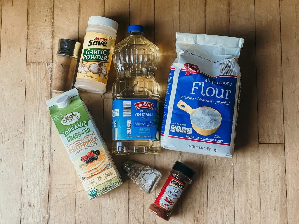 ingredients for fried chicken on a wooden surface