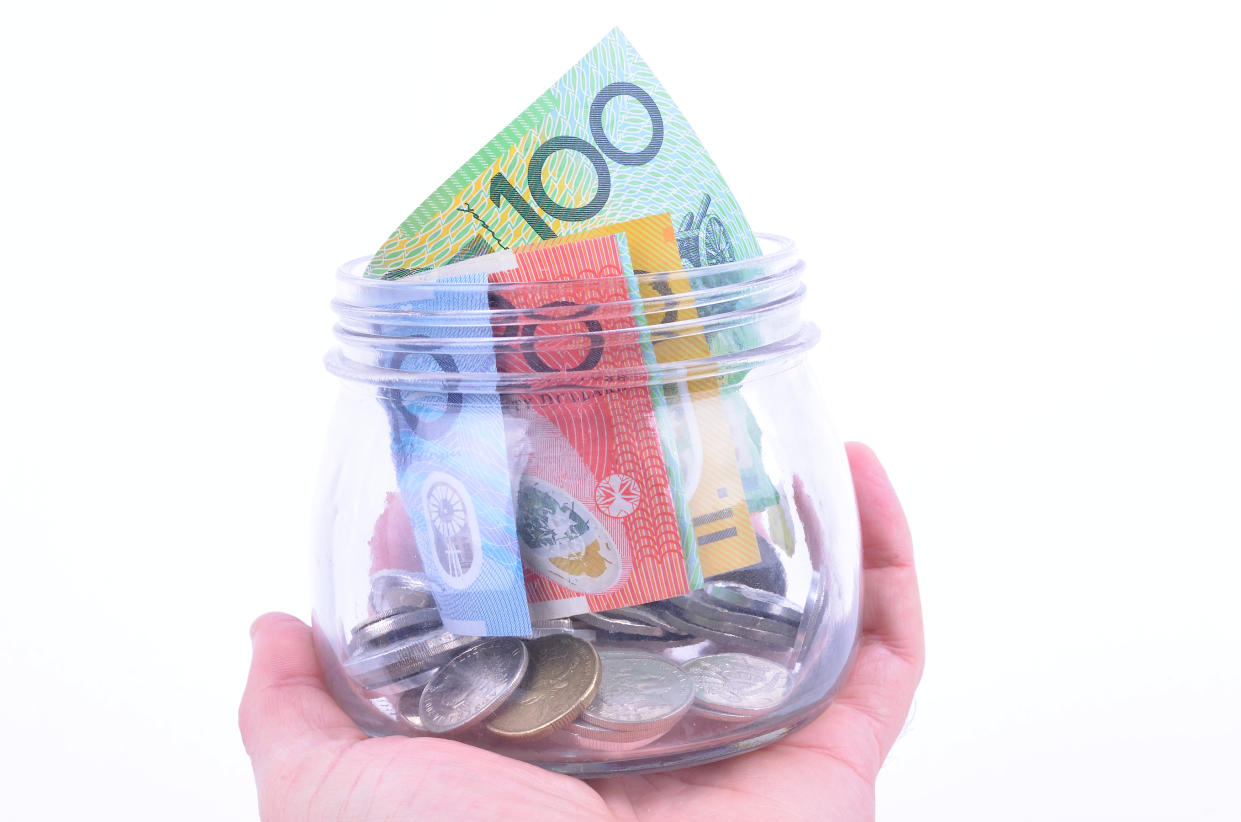 A glass jar full of Australian money