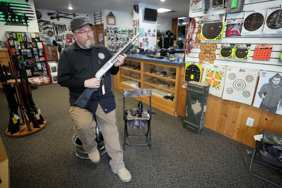 Chuck Lovelace, owner of Essential Shooting Supplies, uses an unloaded shotgun to demonstrate the sound it makes when it’s racked at his gun shop in Park Falls. Lovelace explained situations where customers purchase shotguns hoping the sound of the racking is enough to fend off intruders.