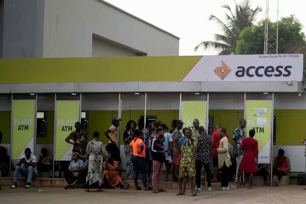 PHOTO: People wait in front of a bank as they attempt to withdraw cash from their savings in Anambra state, southeastern Nigeria, on Feb. 24, 2023. (Mosa'ab Elshamy/AP)