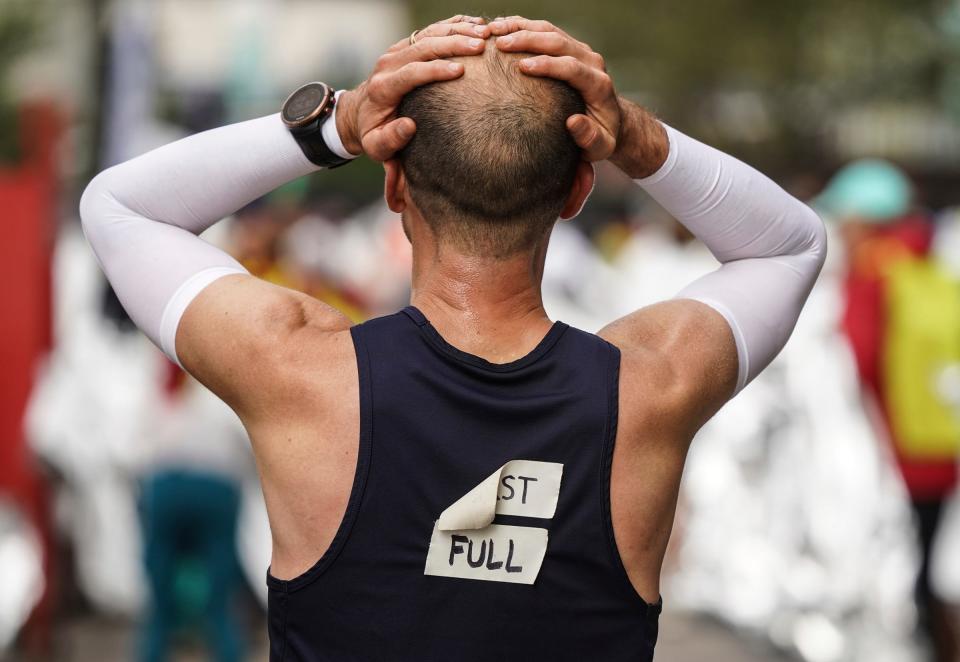 Quinn Strassel, of Ann Arbor, reacts after finishing his first marathon during the 46th Annual Detroit Free Press Marathon presented by MSU Federal Credit Union in Detroit on Sunday, Oct. 15, 2023.