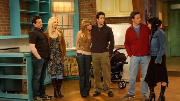 The group stands around an empty apartment in the series finale of Friends.