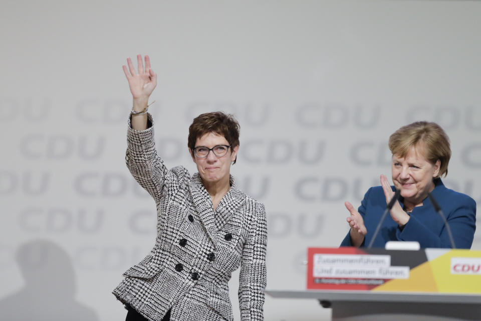 German Chancellor Angela Merkel, right, congratulates newly elected party chairwoman Annegret Kramp-Karrenbauer after the election at the party convention of the Christian Democratic Democratic Union CDU in Hamburg, northern Germany, Friday, Dec. 7, 2018. (AP Photo/Markus Schreiber)