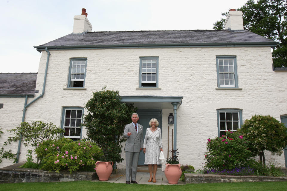 Camilla, Duchess of Cornwall and Prince Charles, Prince of Wales pose for a photograph outside their welsh property Llwynywermod before a drinks reception on June 22, 2009 in Llandovery, United Kingdom. The Duchess of Cornwall and the Prince of Wales are on their annual 'Wales Week' visit to the region and will be staying at the recently refurbished property.  (Photo by Chris Jackson/WPA Pool/Getty Images)