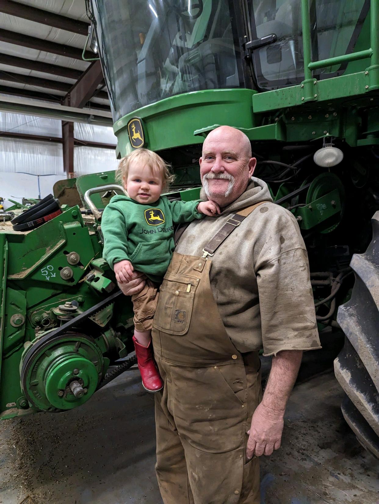 Colorado River family farmer in front of combine