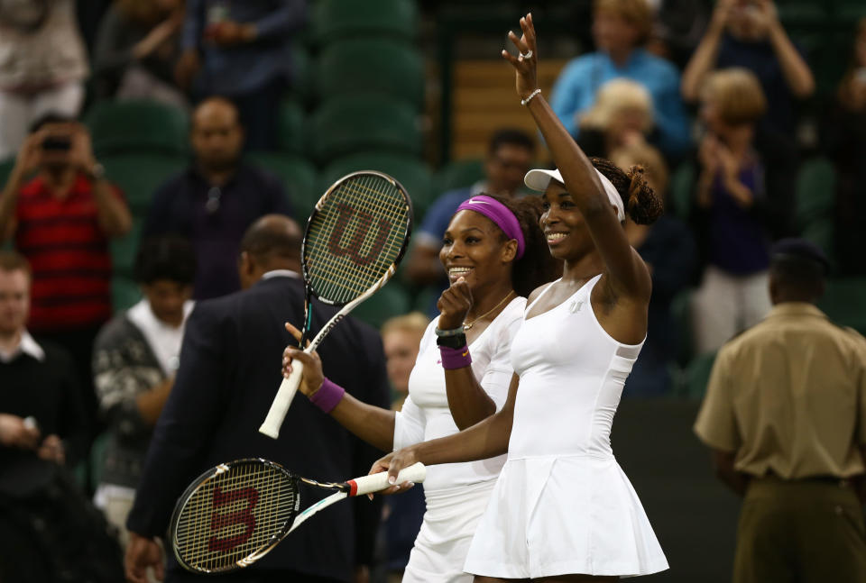 <b>Williams sisters</b><br>The Williams are undefeated in Olympic doubles play, winning the gold at the 2000 and 2008 Games. They also have 13 Grand Slam doubles title, five of them at Wimbledon. Here, they celebrate the most recent of their doubles titles, won on July 7 at Wimbledon's All-England Club. (Photo by Paul Gilham/Getty Images)