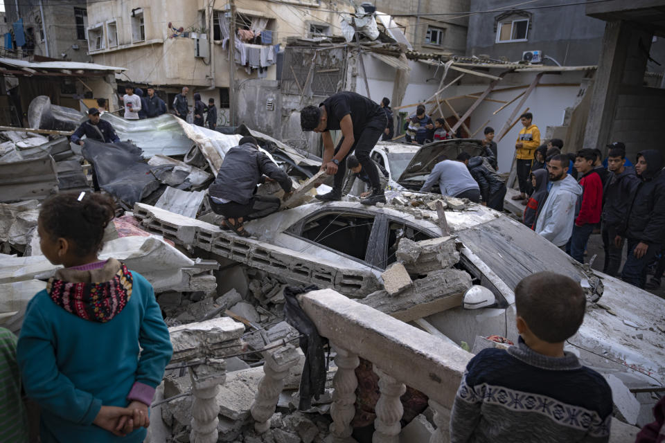 FILE Palestinians inspect a house after it was hit by an Israeli bombardment on Rafah, southern Gaza Strip, Wednesday, Dec. 20, 2023. Israel and Hamas have been at war for 100 days. The war already is the longest and deadliest between Israel and the Palestinians since Israel’s establishment in 1948, and the fighting shows no signs of ending. (AP Photo/Fatima Shbair, File)