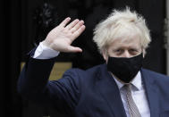 Britain's Prime Minister Boris Johnson waves as he leaves 10 Downing Street in London, Thursday, Nov. 26, 2020. Johnson leaves self-quarantine today after having close contact with a lawmaker who contracted the coronavirus in mid November. (AP Photo/Kirsty Wigglesworth)